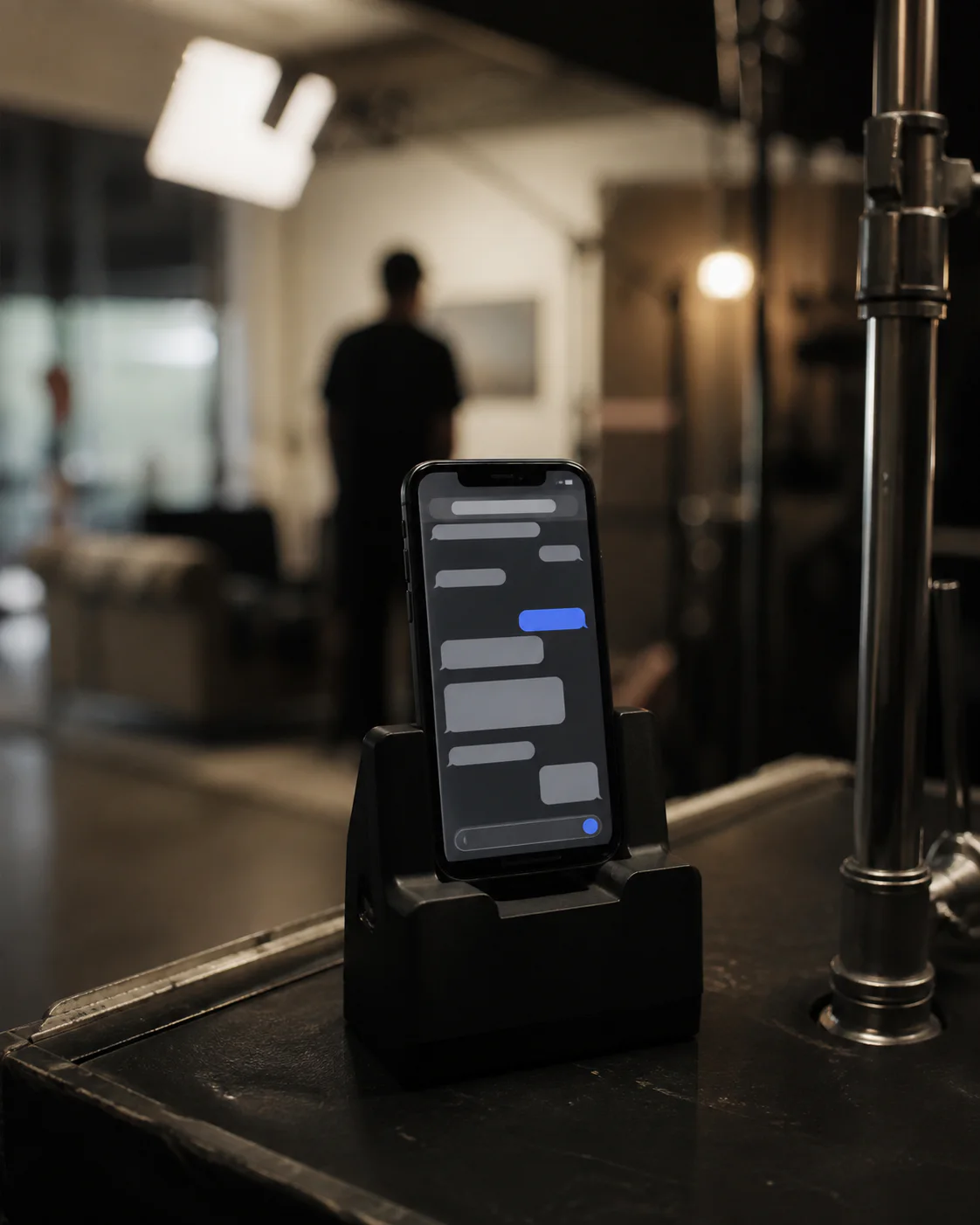 Practical smartphone prop prepared in a continuity cradle on set