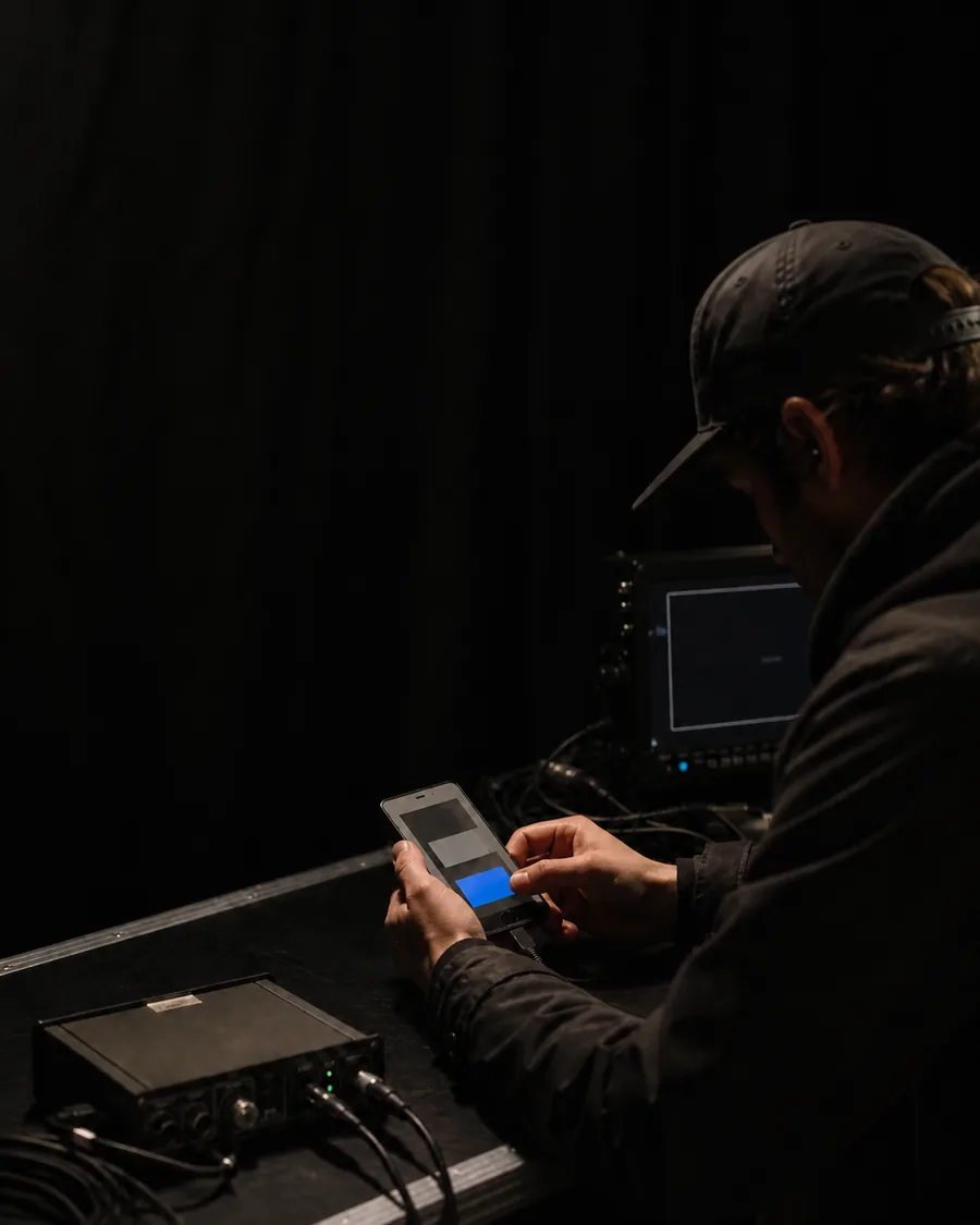 Technical operator preparing a practical phone prop at a production workstation