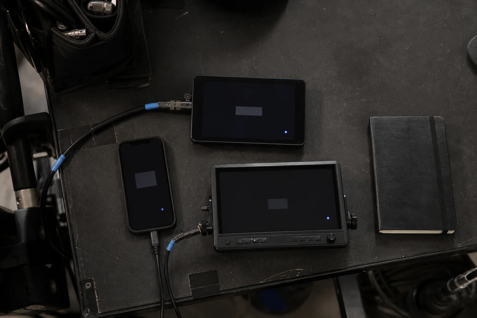 Three coordinated production display devices arranged on a playback cart